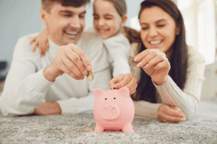 parents teaching kid how to use piggy bank