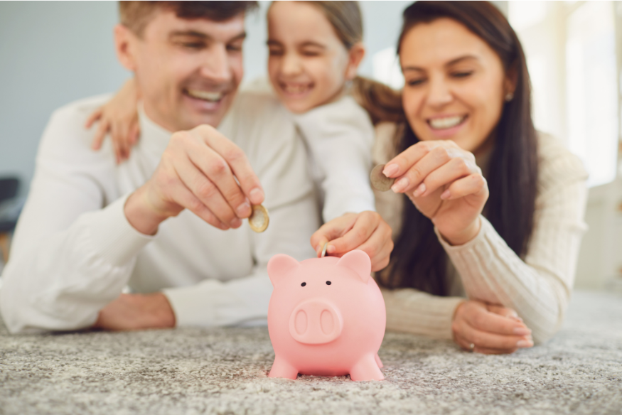 parents teaching kid how to use piggy bank