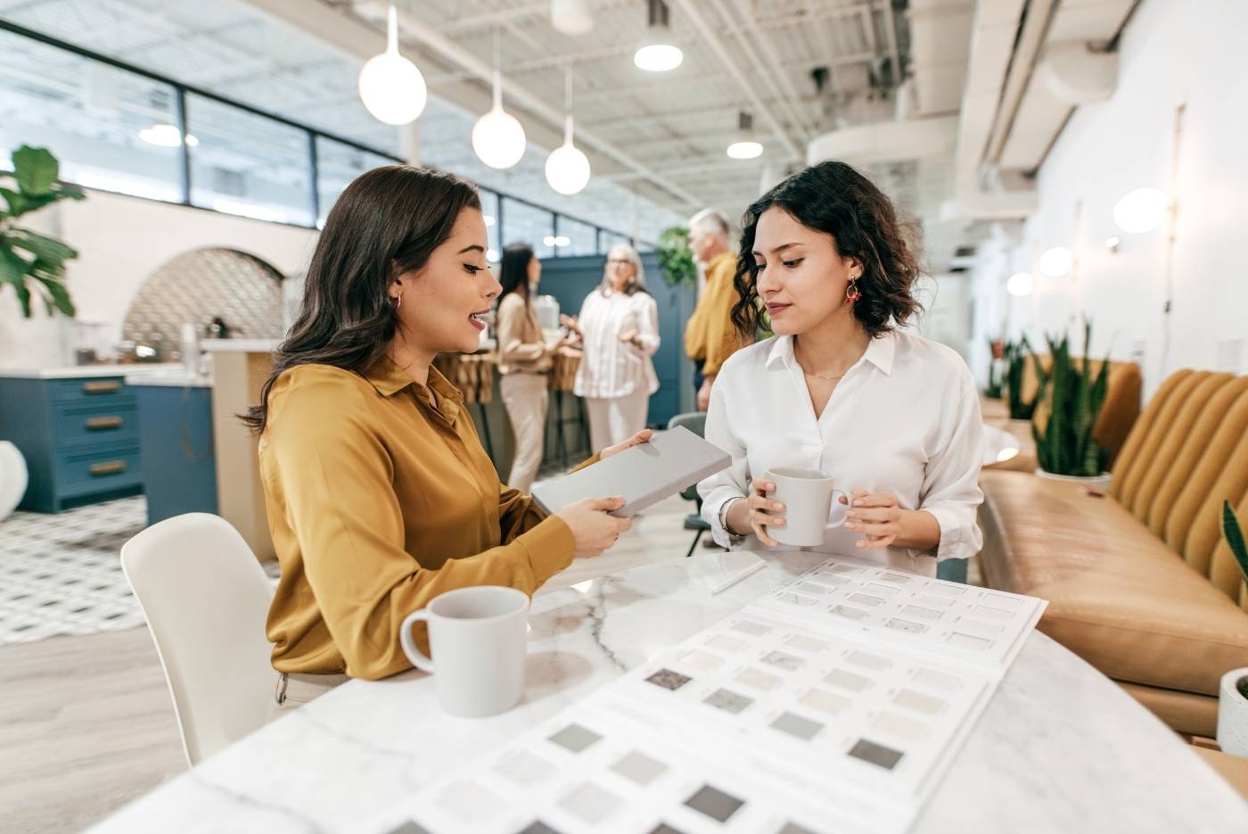 Two women at a table talking about work plans