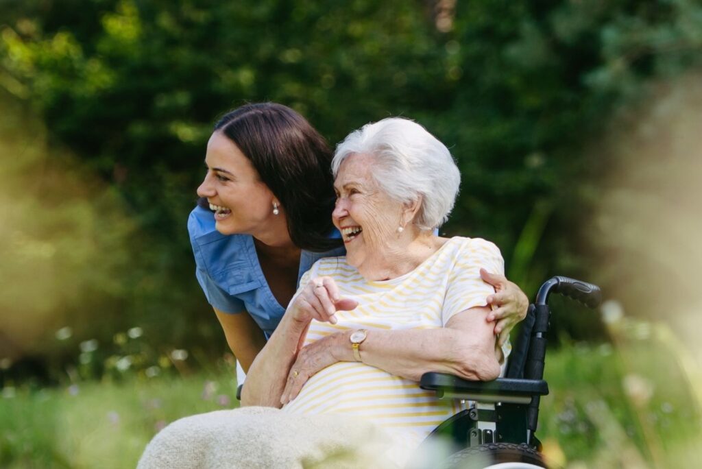 Home Nurse Taking Care of Elderly Woman in Wheelchair